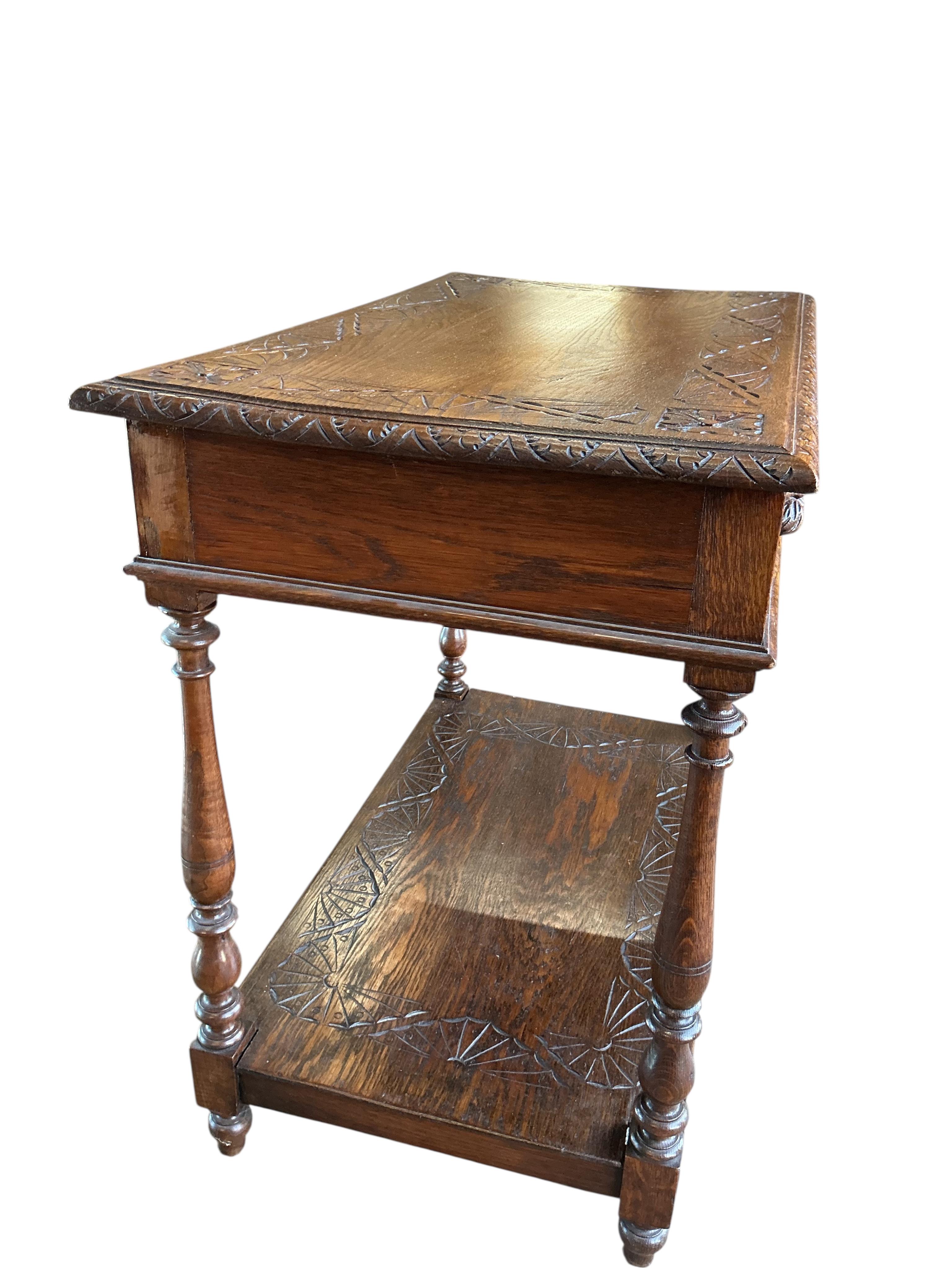 A late Victorian Flemish carved oak two tier table, width 84cm, depth 49cm, height 75cm